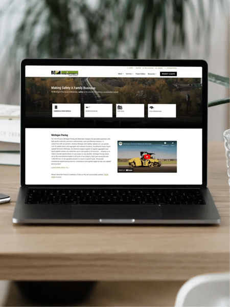 Michican Paving website home page displayed on a laptop